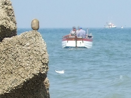 Et dans l'anse rocheuse en contrebas, un flobart vient de prendre la mer Et dans l'anse rocheuse en contrebas, un flobart vient de prendre la mer